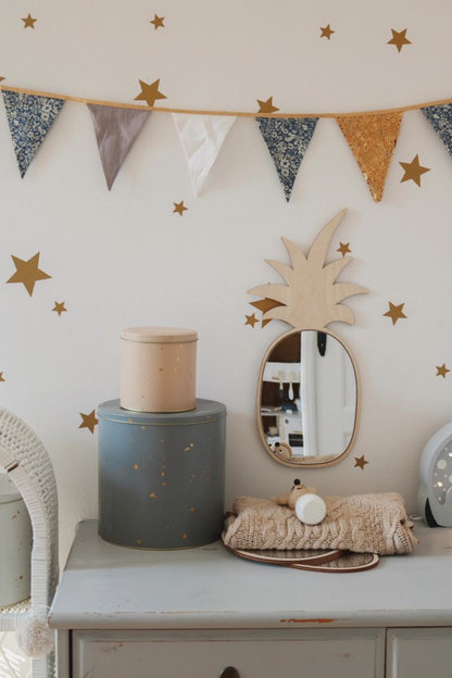 Pineapple mirror with acrylic reflective surface styled on dresser with star wall decals