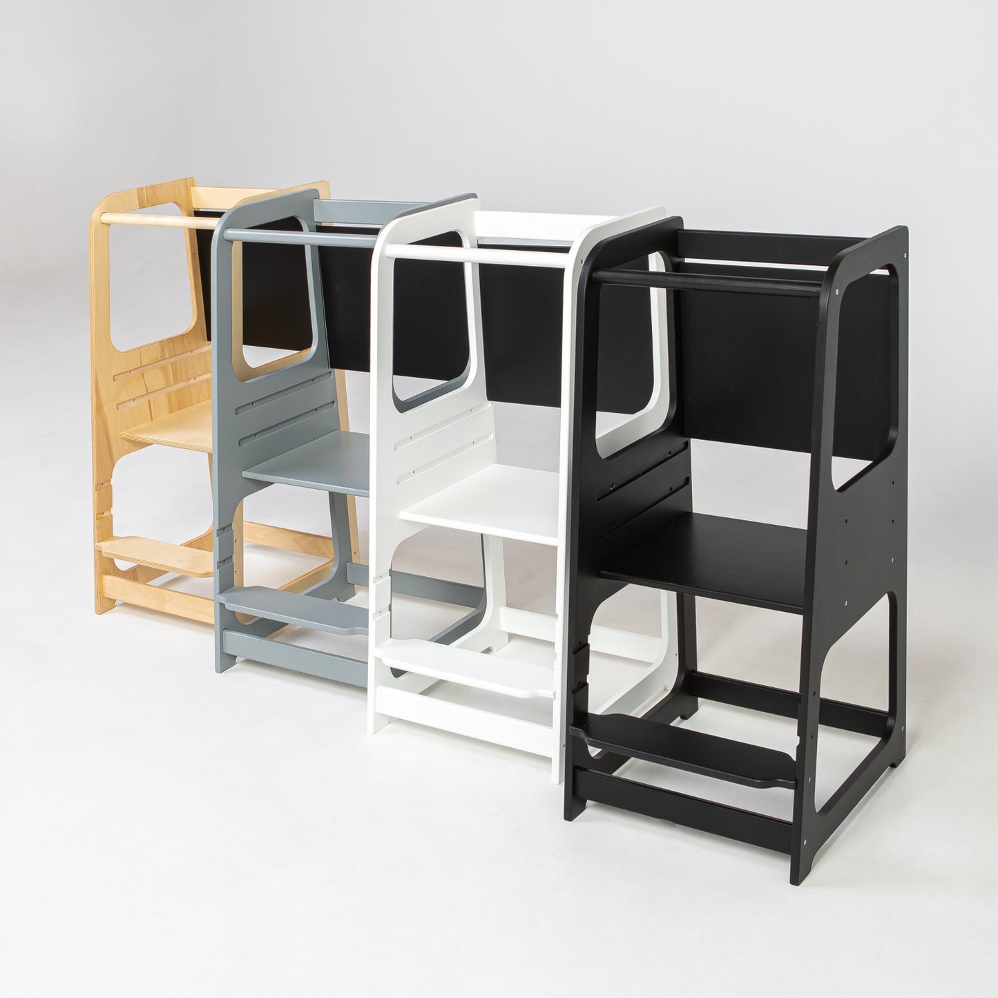 Four color options of wooden kitchen helper towers including natural, gray, white and black