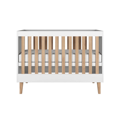 Kocot Kids Baby Bed Kubi White Scandinavian Crib – front view white wooden cot with oak legs | Nestling