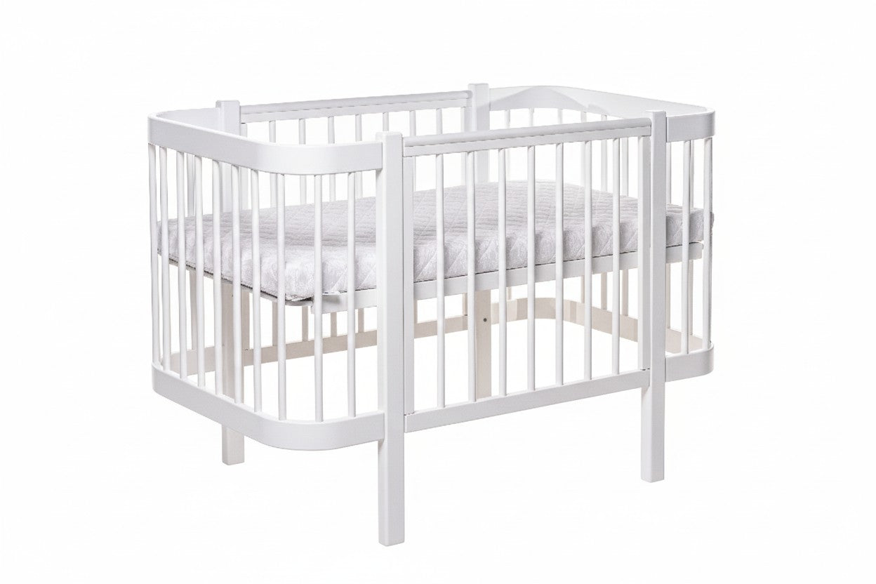 KOTTO Baby Crib ELIN with Mattress White Beechwood Bundle – angle view crib with beechwood legs | Nestling