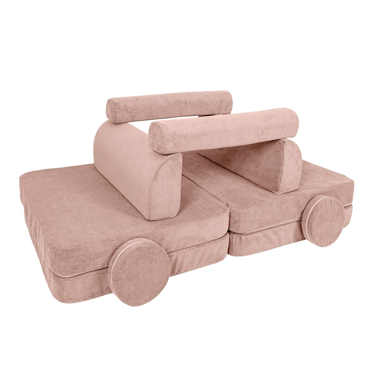 Pink modular sofa rearranged into play structure with wheels and stacked foam blocks