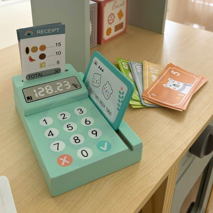 Turquoise card reader with calculator buttons and receipt display with play food items