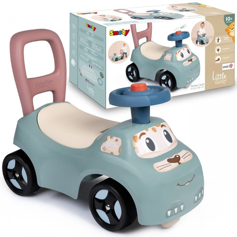 Turquoise ride-on pusher car with pink handle, cream seat, and removable blue horn displayed with packaging