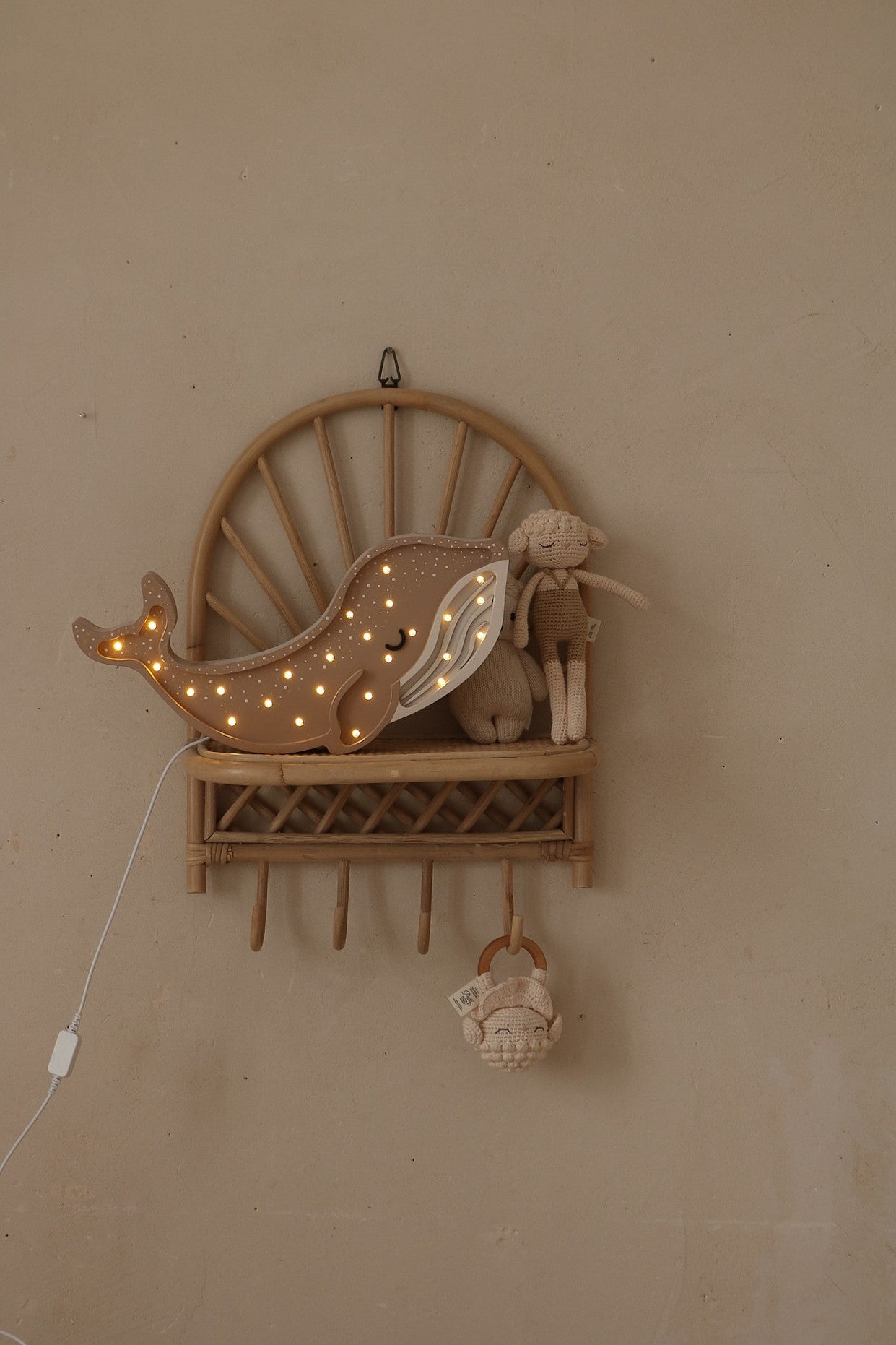 Natural wood whale lamp mounted on wall shelf with warm white LED lights and cord