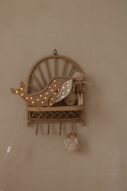 Natural wood whale lamp mounted on wall shelf with warm white LED lights and cord