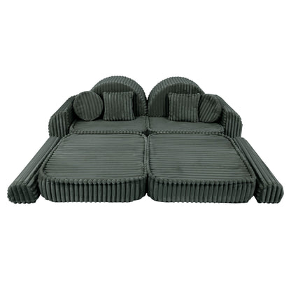 Forest green modular sofa front view with two cushioned seats, pillows and curved design