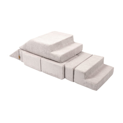 Soft velvet bricks stacked to form a playground structure with multiple levels and stairs