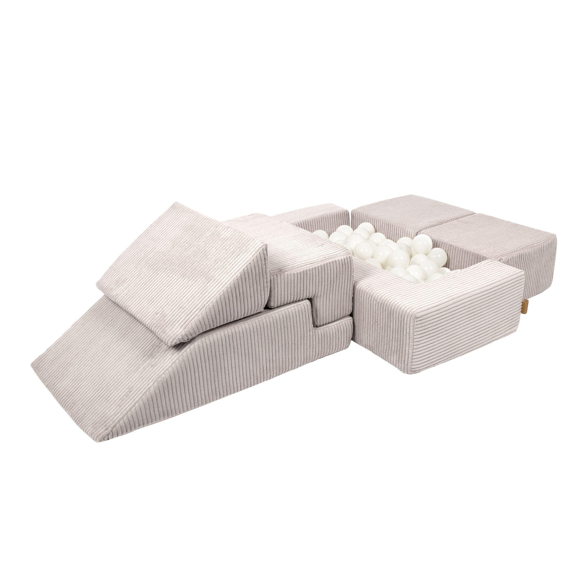 Soft velvet modular bricks assembled as ball pit with cream-colored play balls inside
