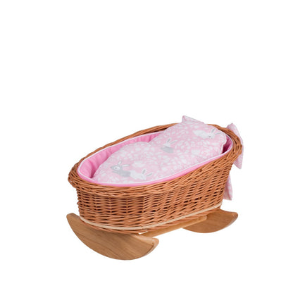 Wicker doll cradle with natural wooden rockers, pink patterned bedding, pillow and duvet