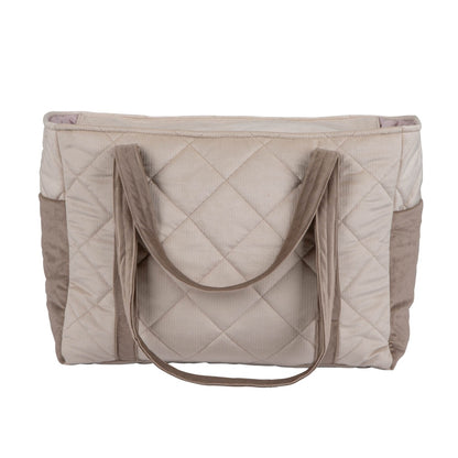 Front view of beige quilted velvet mom bag with structured handles and multiple outer pockets