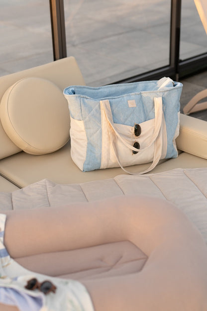 Jeans weekender bag displayed on cushioned seating as a maternity hospital bag