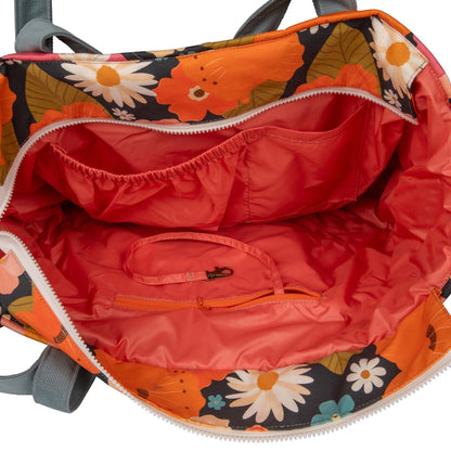 Interior view of mom weekender bag showing red waterproof lining and organized pockets
