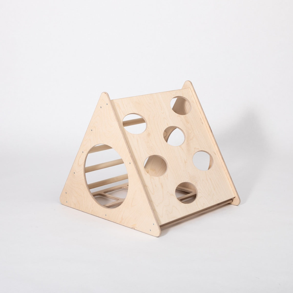 Wooden climbing triangle showing both sides with oval and circular cutouts