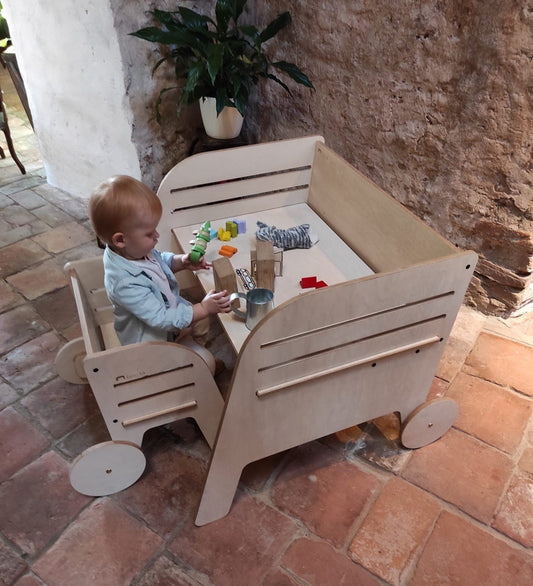 Toddler using Luula Julle Montessori table with chair for sensory play and art activities