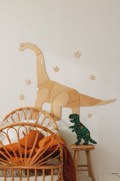 XL wooden diplodocus dinosaur wall piece displayed above wicker bed with toy figure