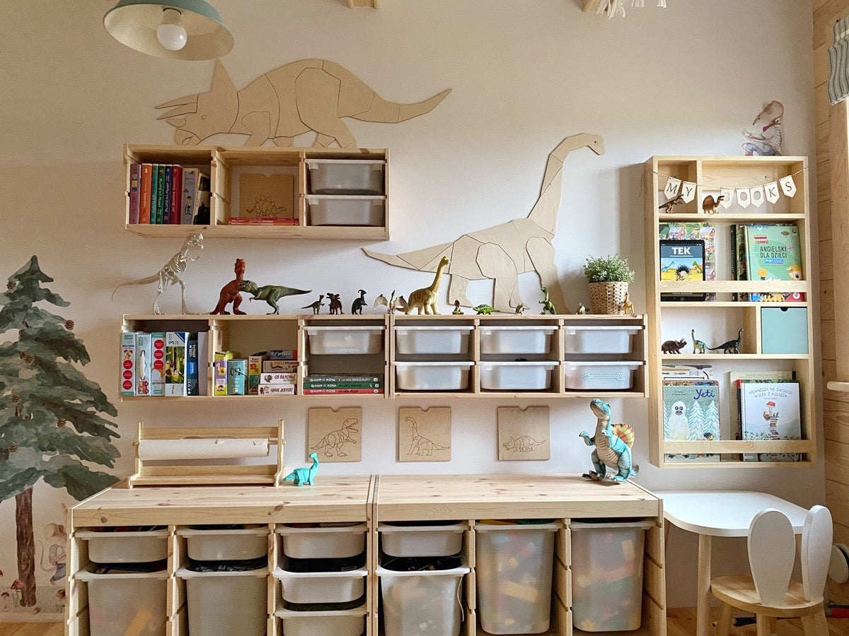 Oversized wooden diplodocus decoration spanning white shelving unit in contemporary playroom storage
