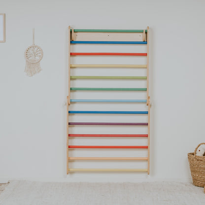 Two-section Swedish wall mounted vertically showing rainbow colored climbing bars