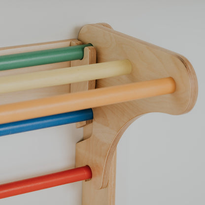 Close-up of birch plywood frame detail with colorful wooden climbing bars