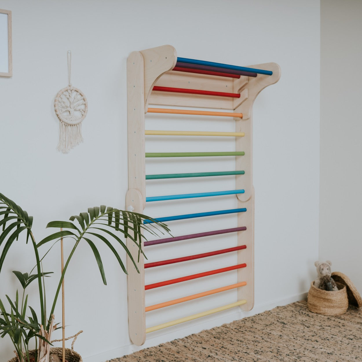 Rainbow Swedish wall mounted on white wall showing full height climbing bars