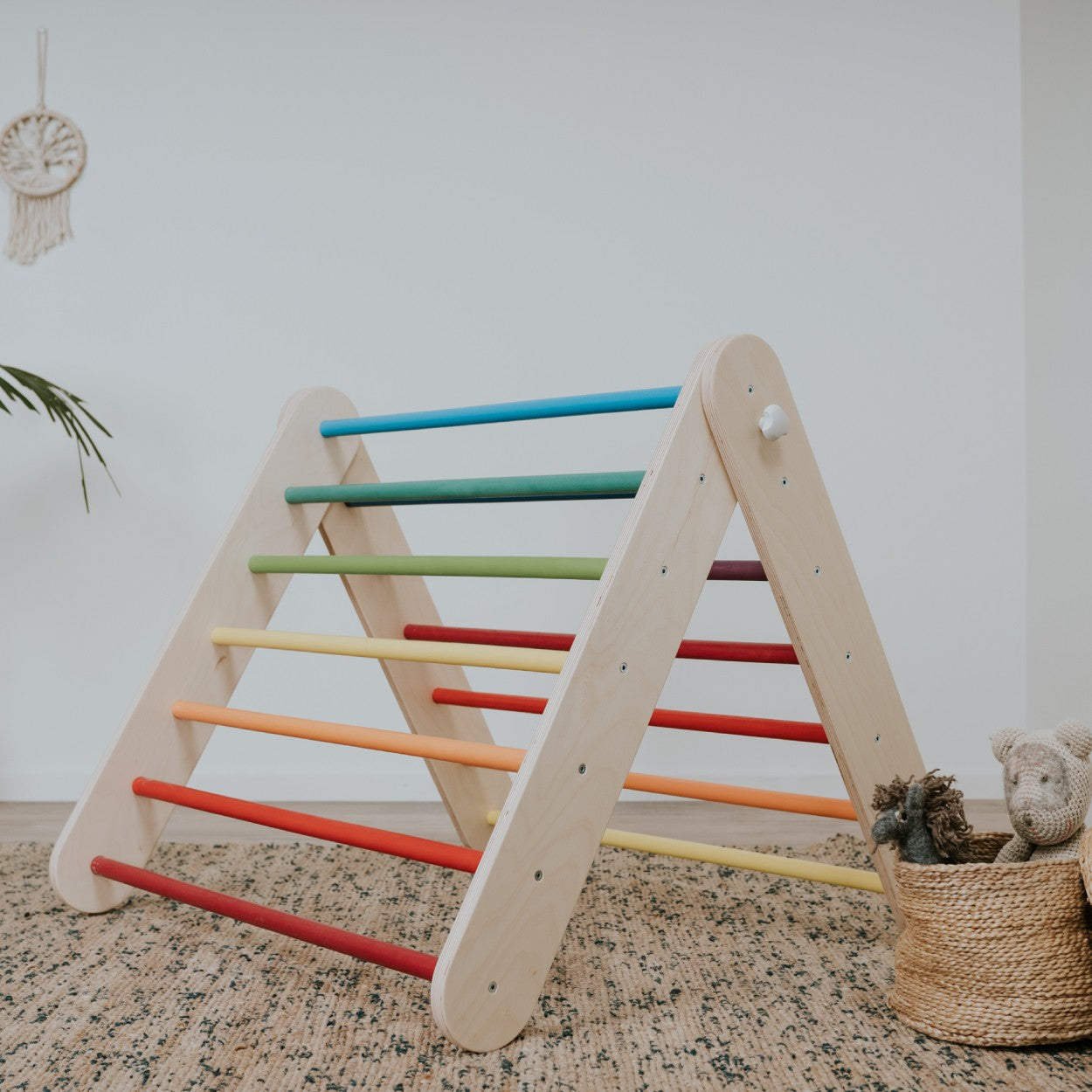 A-frame Pikler triangle climber with rainbow bars in natural wood and bright colors