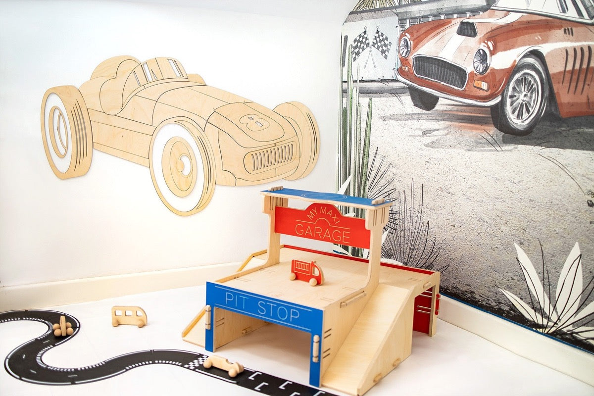 Wooden car wall decor parts displayed with assembled wooden garage and racing track set