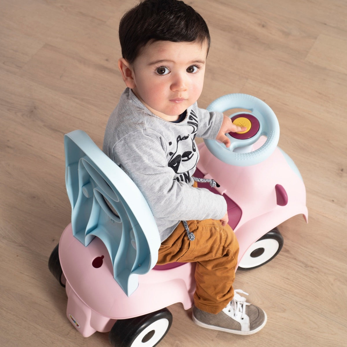 Toddler scooting on pink Maestro 3in1 without accessories showing core ride-on design