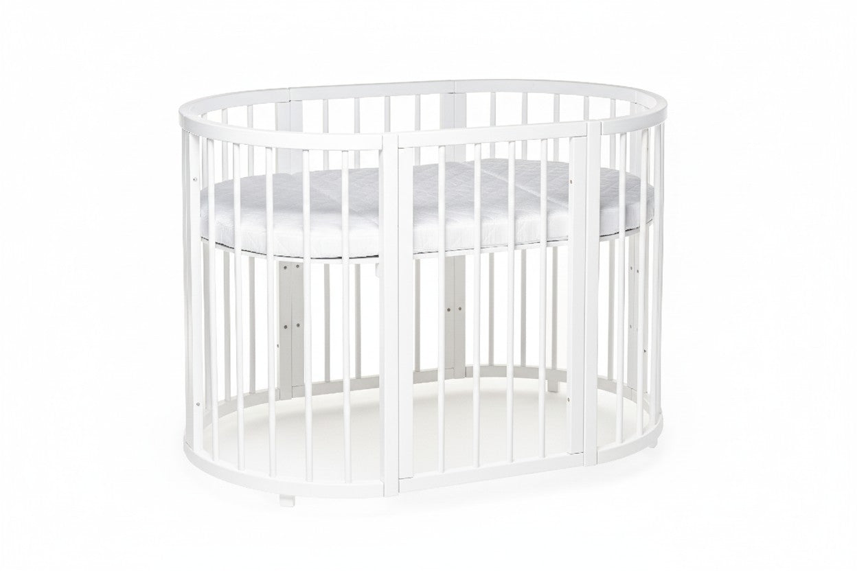 Toddler playing inside white round crib showing spacious interior and protective rail design