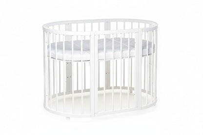 Toddler playing inside white round crib showing spacious interior and protective rail design