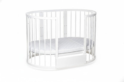 White round crib with one removable side panel and included mattress