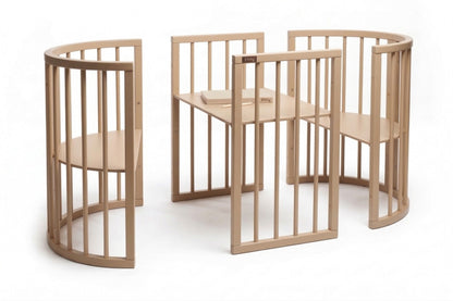 OLIN round crib shown in multiple configurations as open daybed and classic crib setup