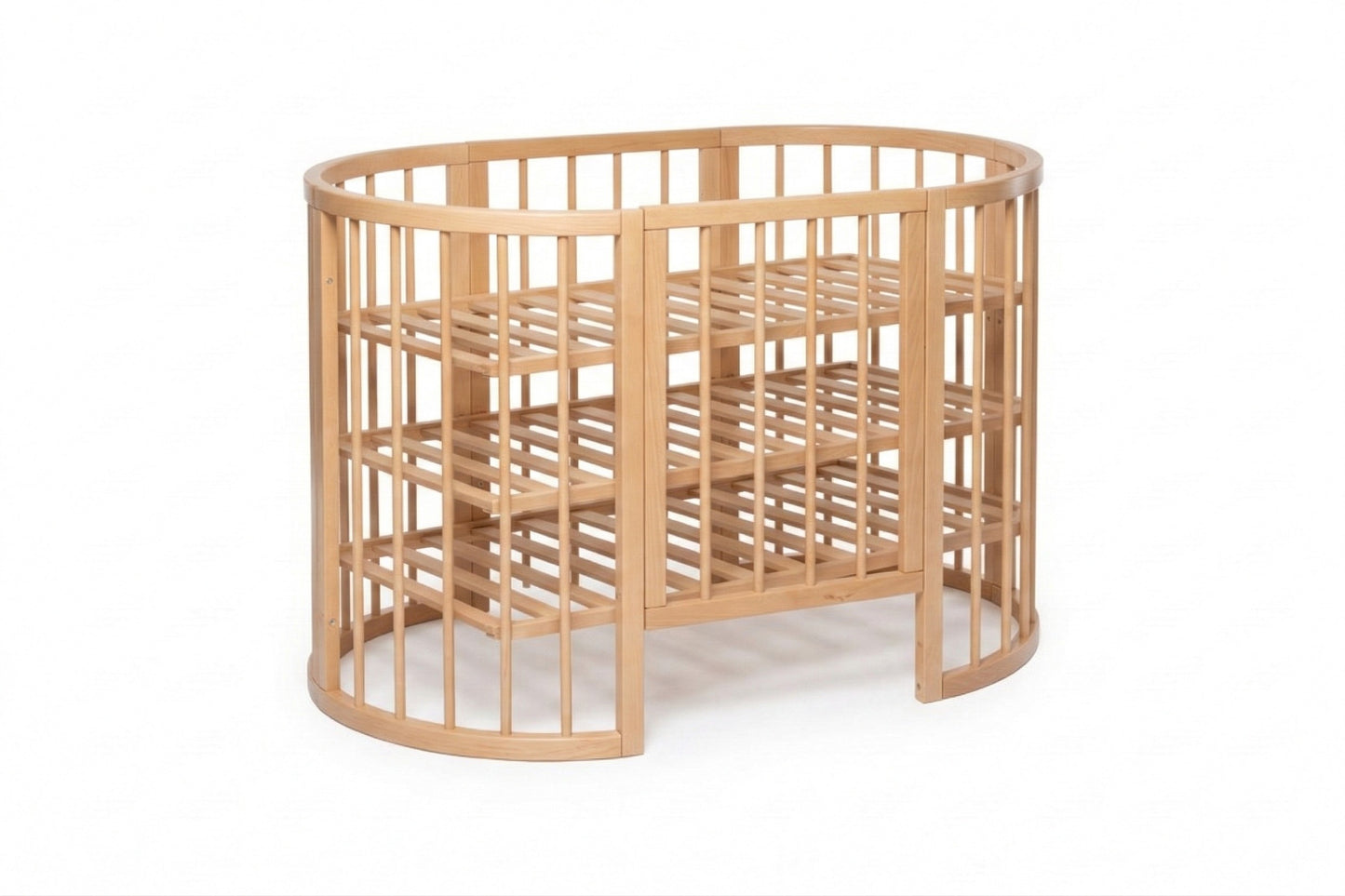 Oval-shaped beech wood crib with slatted sides and three mattress heights