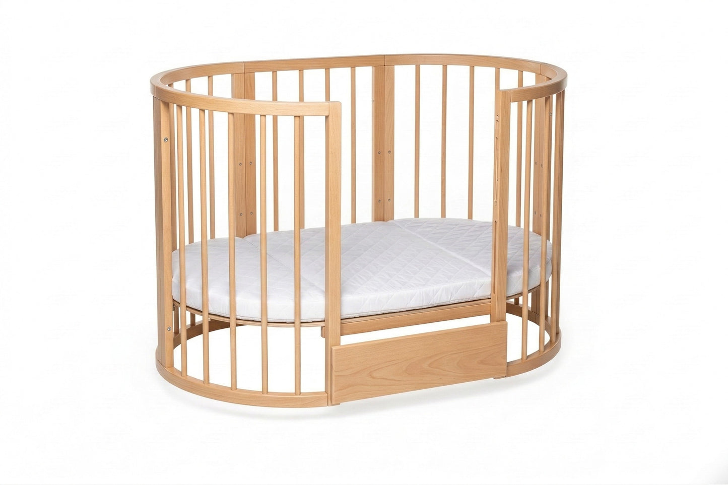 Natural wood oval crib with white mattress and adjustable base height