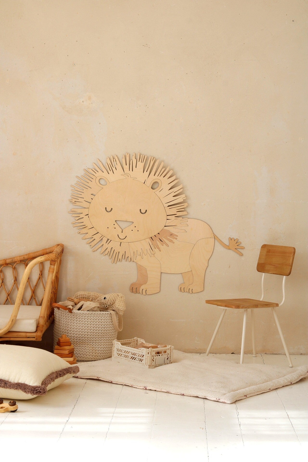 Single wooden lion wall decoration with textured mane mounted above storage basket