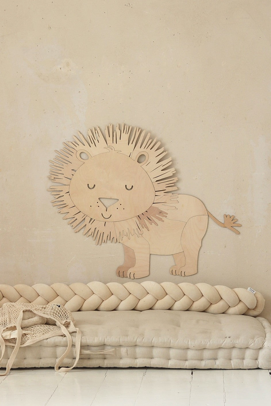 Close-up of wooden lion wall art showing detailed mane and gentle facial features