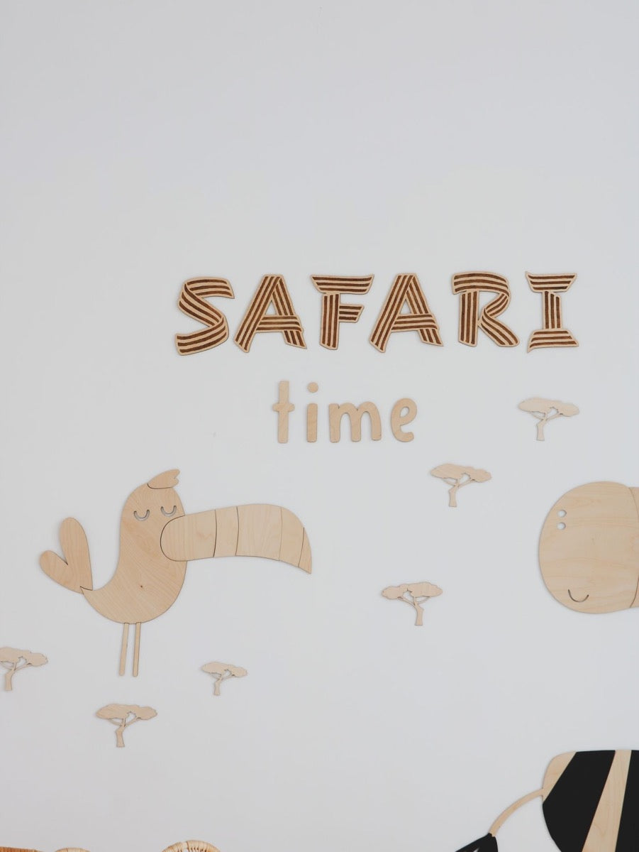 Safari Time wooden wall decoration with toucan, lion, and baobab tree elements assembled on white wall