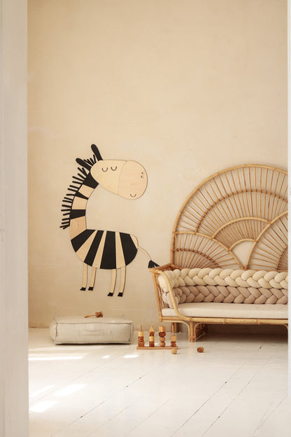 Large wooden safari zebra wall art mounted above natural fiber storage in kids room