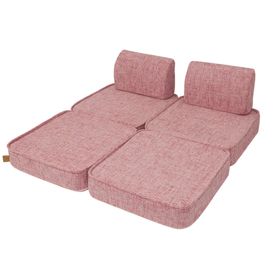 Bubblegum pink modular kids sofa in expanded configuration with four cushion sections