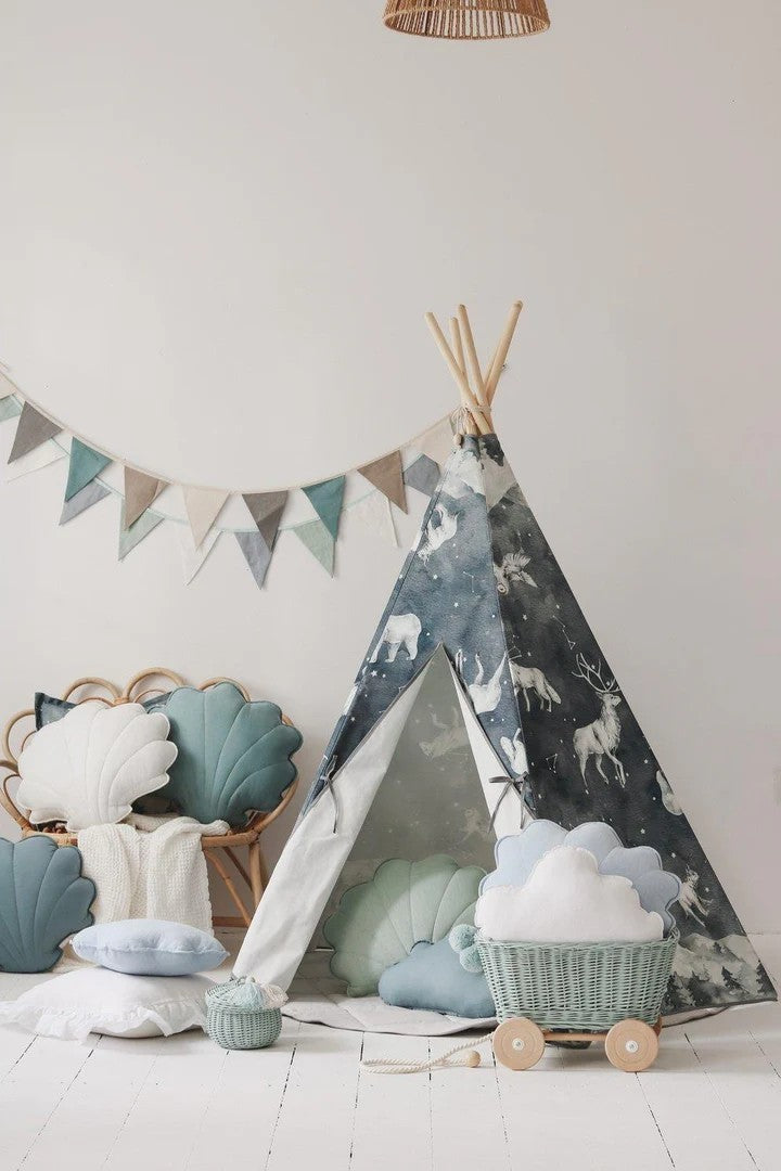 Night Sky teepee tent styled in a playroom with pillows, baskets, and decorative bunting