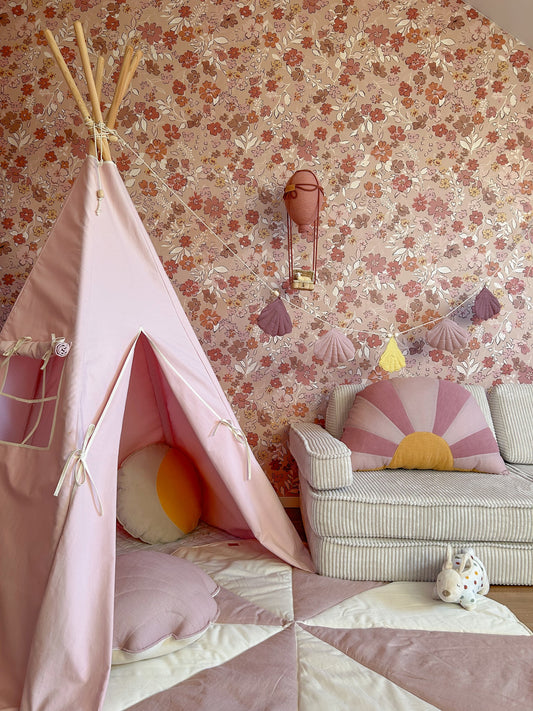 Pink cotton teepee tent set up indoors with floral wallpaper, showing open entrance and side pocket
