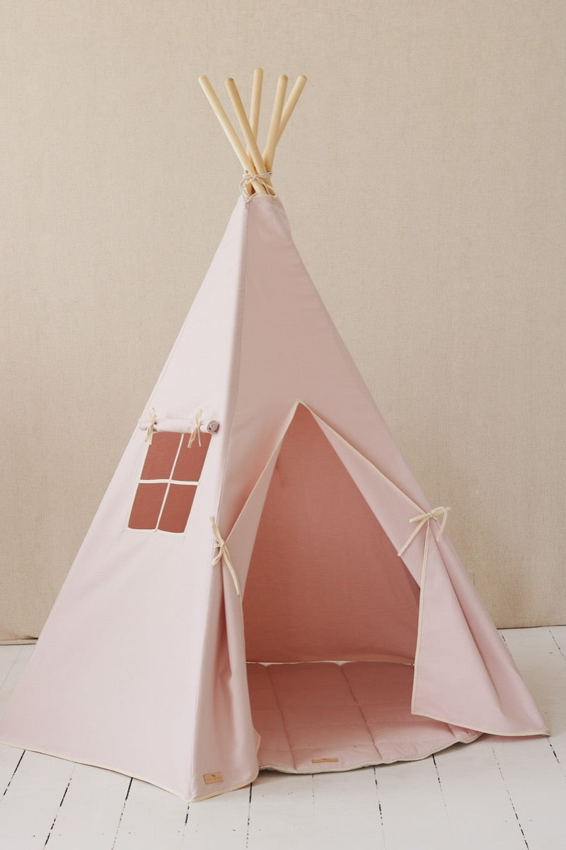 Front view of pink teepee tent with pine poles, window with curtains, and open entrance door