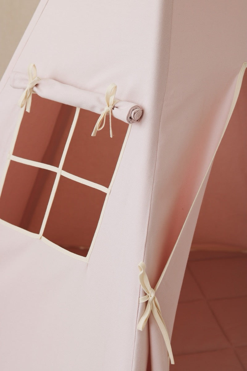 Close-up of teepee window with tied curtains and interior pocket detail on pink cotton fabric