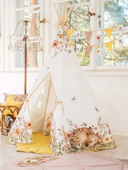 Wildflowers teepee tent with meadow print displayed in bright playroom with yellow mat and decorative bunting