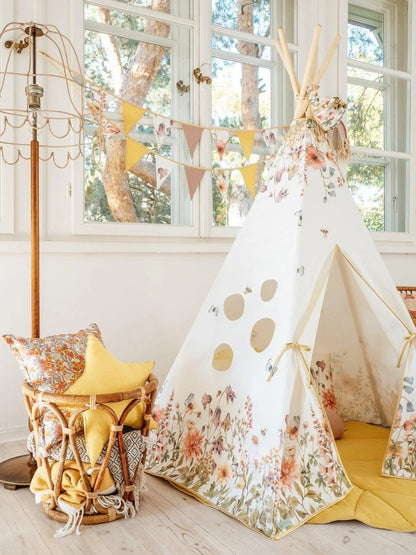 Side angle of cotton play teepee showing all window openings and full meadow-inspired wildflowers pattern
