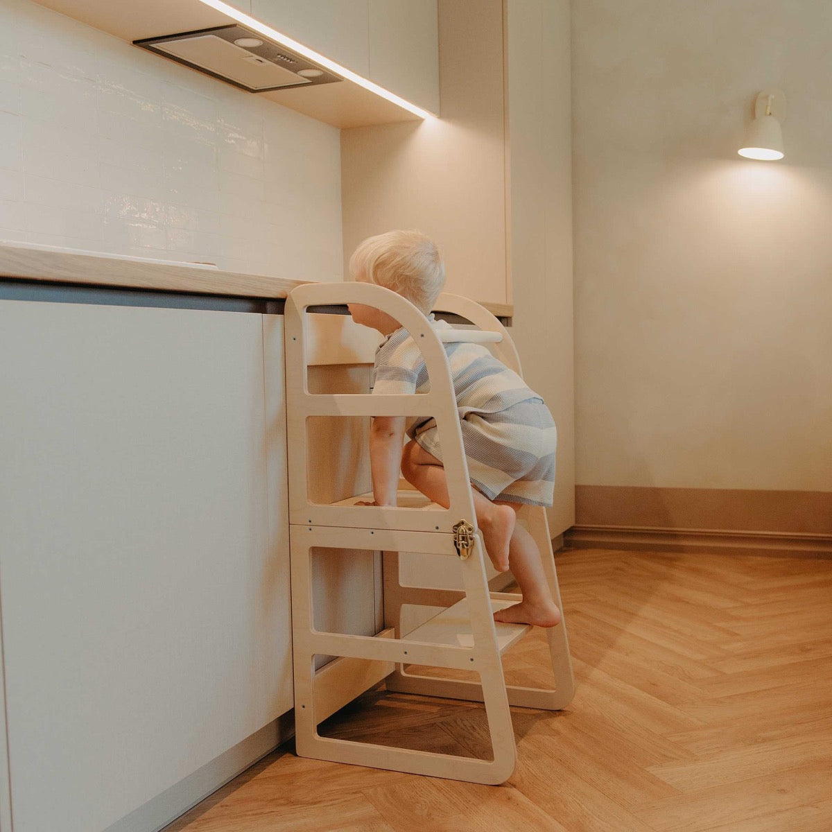 Front view of natural wood kitchen tower showing rounded frame design