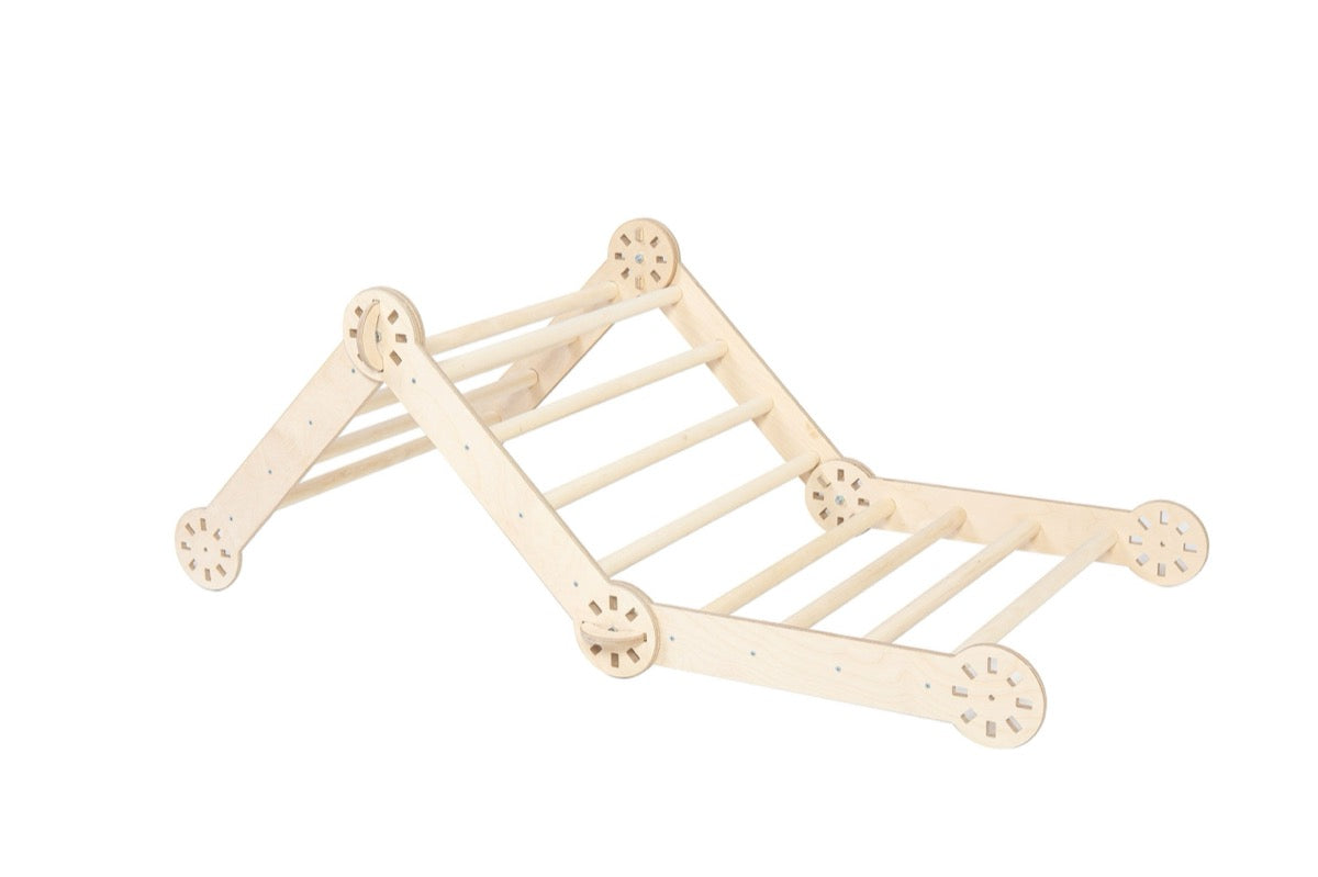 Foldable climbing triangle with attached ramp in low angle side view