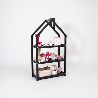Black house-shaped shelf with three compartments holding toys and decorative items