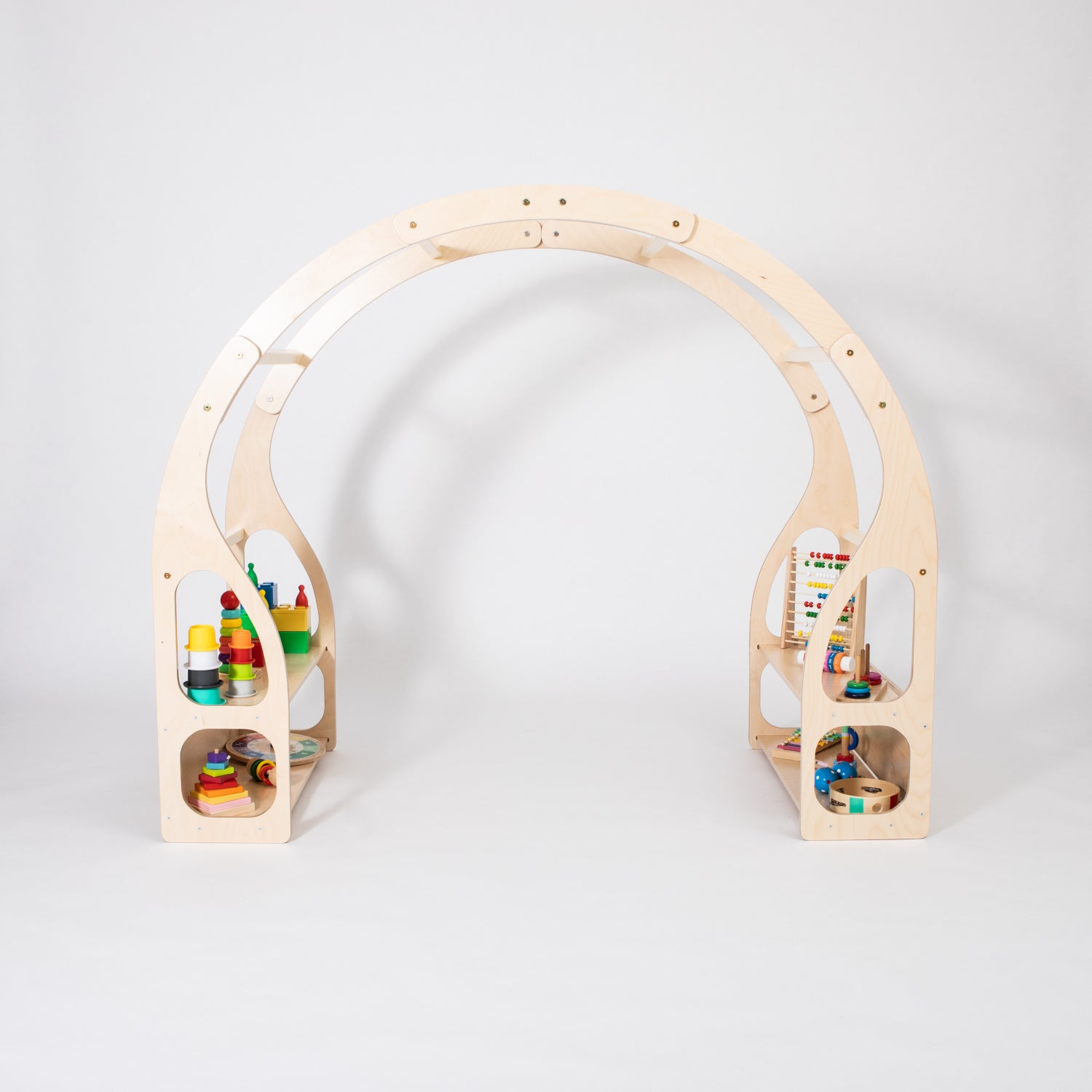 Wooden play stand with colorful stacking blocks visible in lower shelf compartments