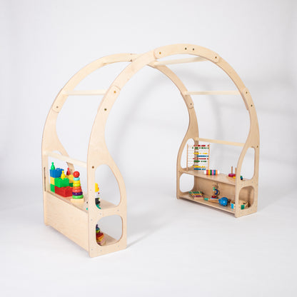 Child playing with toys inside wooden house bed frame with dual shelving units