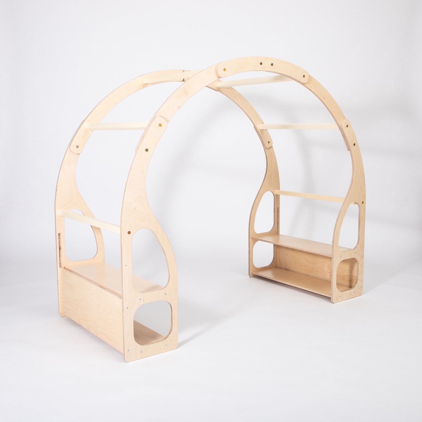 Three-quarter view showing depth of wooden Montessori toy shelf with side shelves