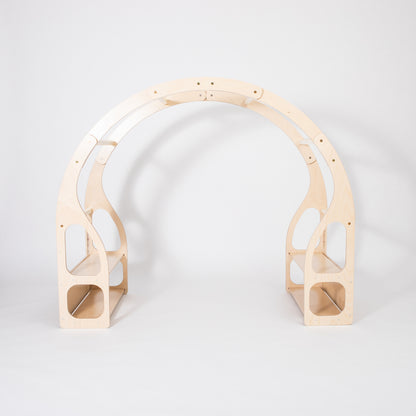 Child crouched inside wooden play stand engaging with toys on built-in shelves